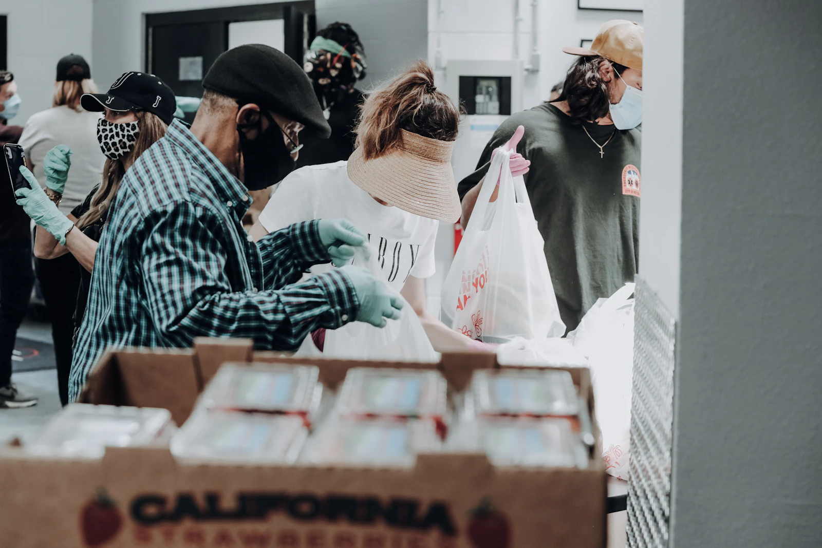 Volunteers gathering around boxes as they work together on community support